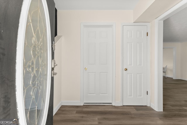 interior space with baseboards and wood finished floors