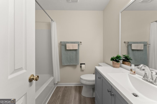 full bath with toilet, vanity, visible vents, and wood finished floors
