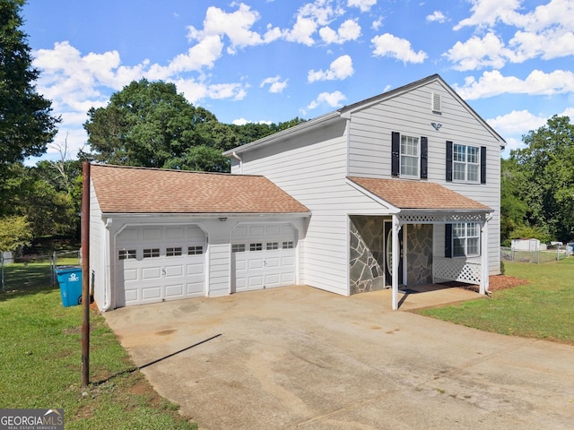 traditional-style house with driveway, fence, a garage, roof with shingles, and a front lawn