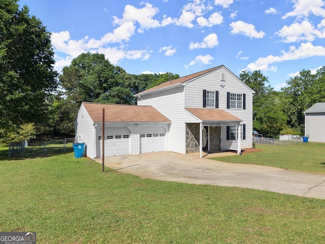 traditional-style house with concrete driveway, a front yard, fence, and a garage
