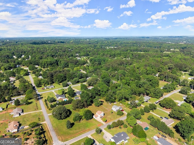 birds eye view of property featuring a view of trees