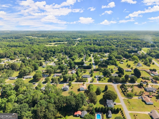 birds eye view of property featuring a view of trees