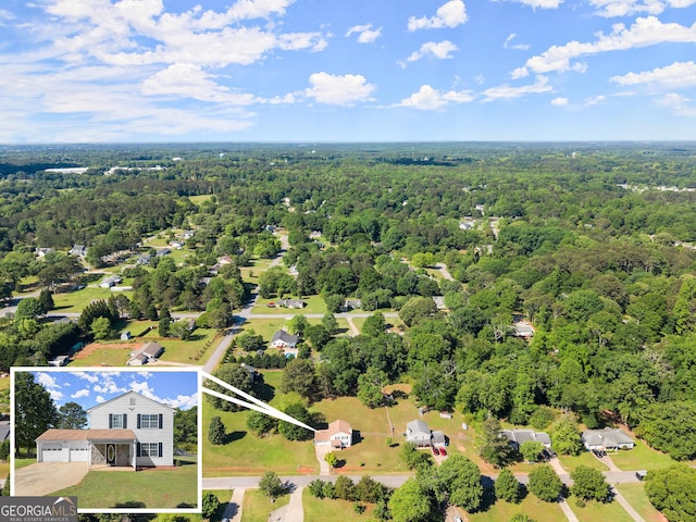 bird's eye view featuring a wooded view