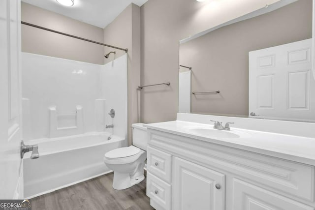 full bathroom with vanity, toilet, tub / shower combination, and wood finished floors