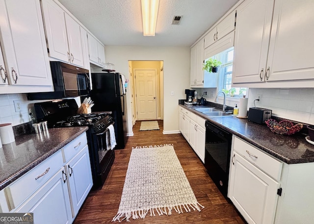 1741 Portwest Way, Hampton, GA 30228 - kitchen with black appliances, white cabinets, dark wood-style flooring, decorative backsplash, and a textured ceiling
