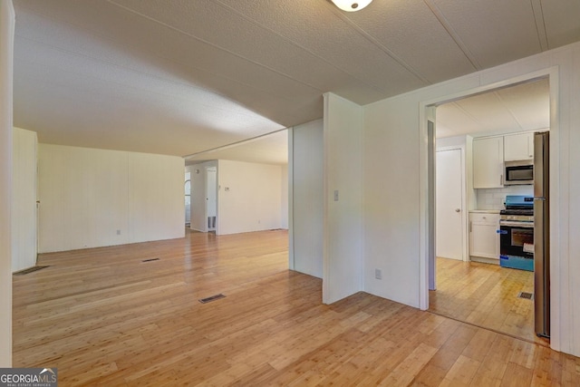 spare room with visible vents and light wood-style flooring