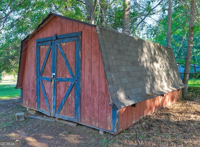 view of shed with fence