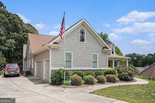 137 New Cut Rd, Winder, GA 30680 - view of home's exterior with cooling unit, driveway, and a garage