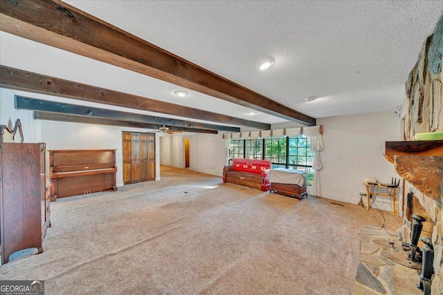 interior space featuring baseboards, beamed ceiling, recessed lighting, and a textured ceiling