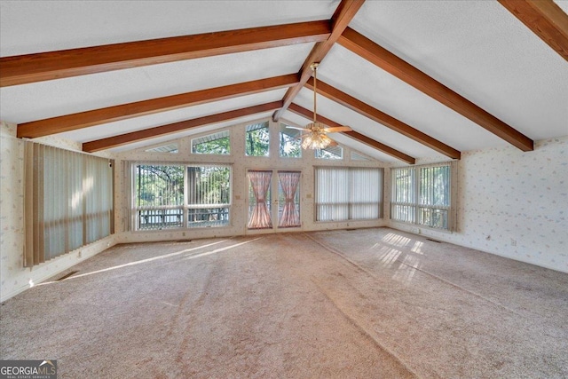 unfurnished living room with carpet, ceiling fan, wallpapered walls, and plenty of natural light
