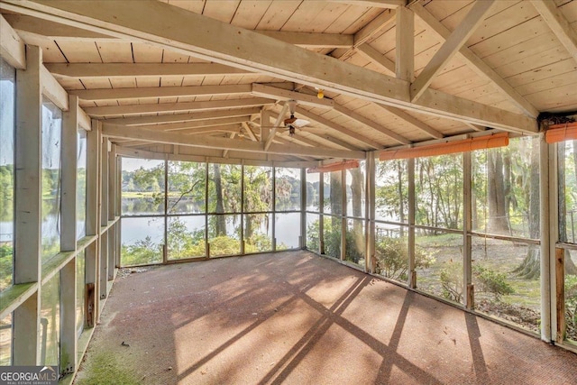 unfurnished sunroom with a water view and ceiling fan