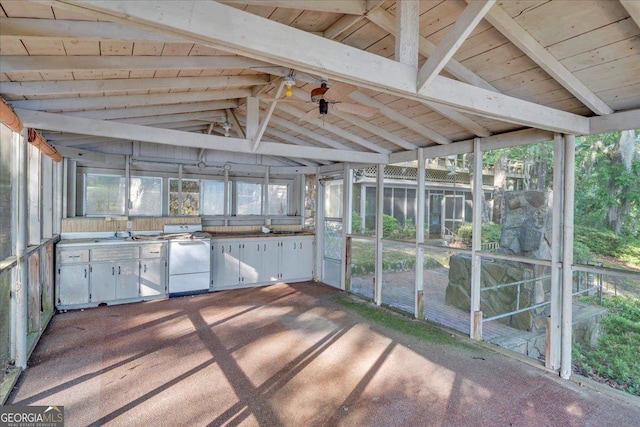 unfurnished sunroom featuring area for grilling and beamed ceiling