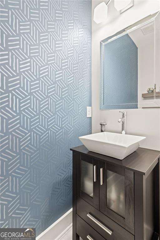 435 Webb Dr, Norcross, GA 30071 - bathroom featuring wallpapered walls and vanity