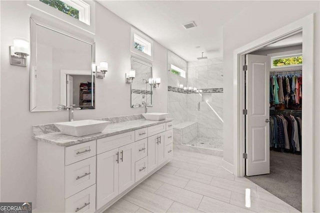 435 Webb Dr, Norcross, GA 30071 - bathroom with visible vents, tiled shower, a spacious closet, and a sink