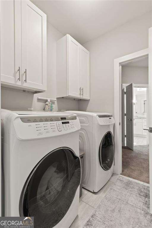 435 Webb Dr, Norcross, GA 30071 - washroom featuring washer and dryer and cabinet space