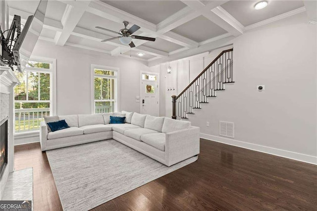 435 Webb Dr, Norcross, GA 30071 - living area with a ceiling fan, visible vents, stairs, a fireplace with flush hearth, and beamed ceiling