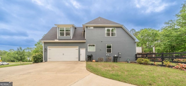 13 Jamilee Cv, Cartersville, GA 30120 - back of property with roof with shingles, fence, a yard, concrete driveway, and a garage