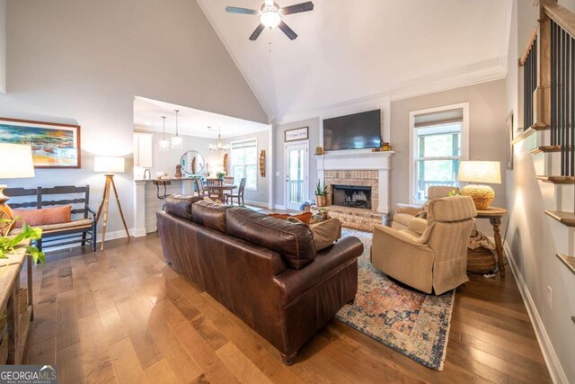 13 Jamilee Cv, Cartersville, GA 30120 - living area with ceiling fan with notable chandelier, stairway, a brick fireplace, wood-type flooring, and baseboards