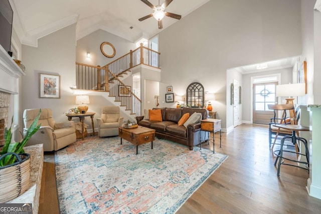 13 Jamilee Cv, Cartersville, GA 30120 - living room with a ceiling fan, high vaulted ceiling, wood finished floors, stairway, and a fireplace
