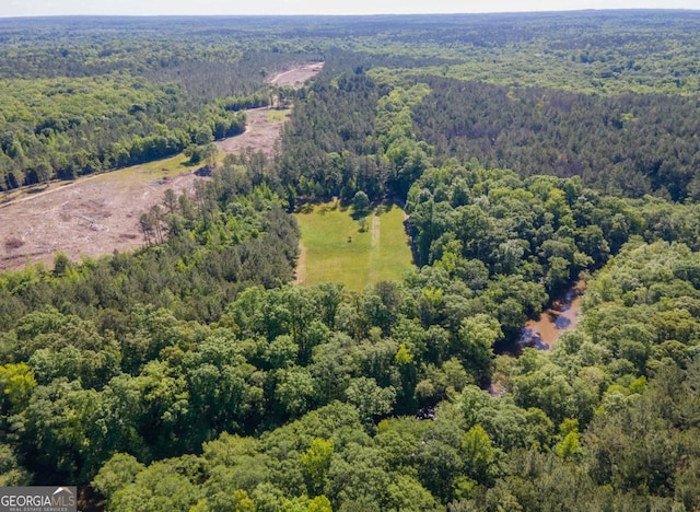 birds eye view of property featuring a forest view