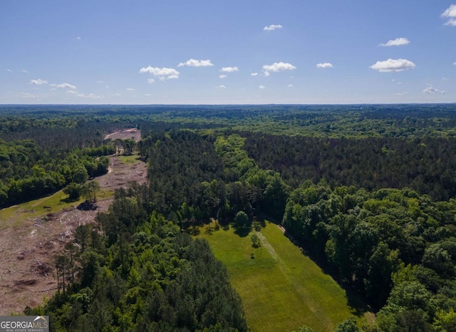 drone / aerial view featuring a forest view
