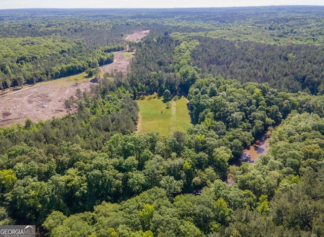 drone / aerial view with a wooded view