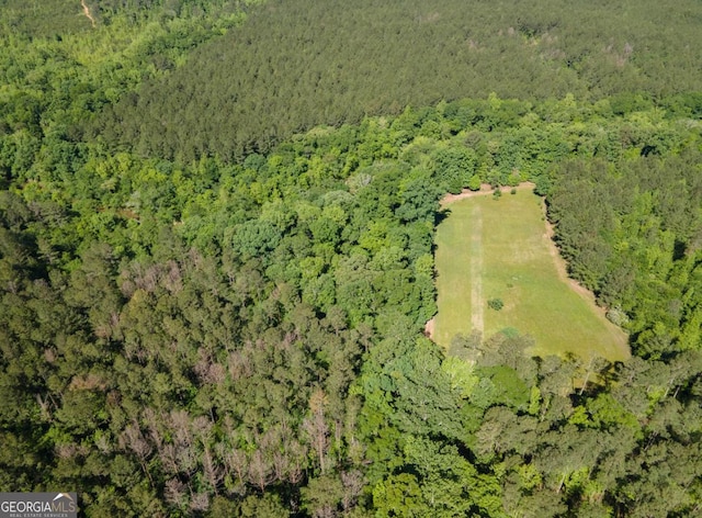 drone / aerial view with a wooded view