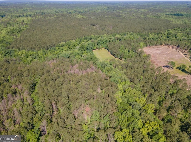 birds eye view of property with a view of trees