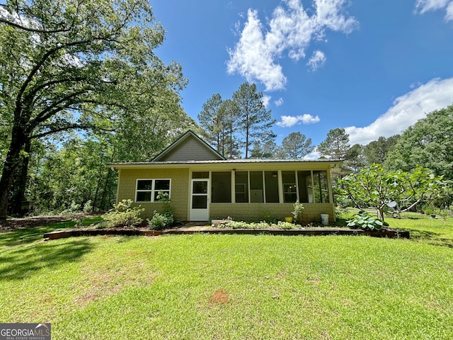 ranch-style home with a sunroom and a front yard