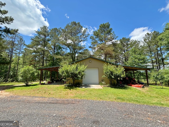 view of front of property with a garage, an outdoor structure, and a front yard
