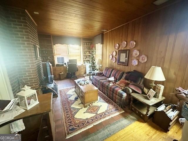 327 W Church St, Swainsboro, GA 30401 - living area featuring wood walls, wood-type flooring, and wood ceiling
