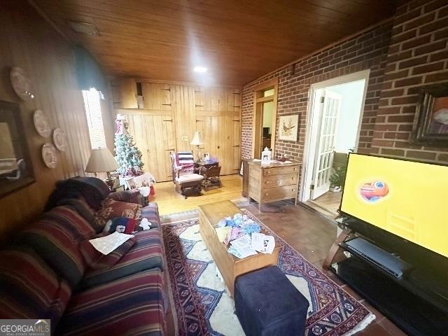 327 W Church St, Swainsboro, GA 30401 - living area featuring brick wall, wood ceiling, and wood finished floors
