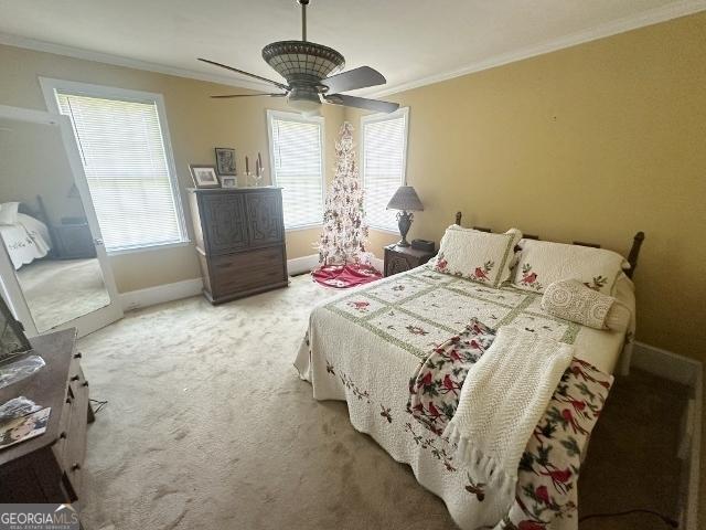 327 W Church St, Swainsboro, GA 30401 - bedroom featuring crown molding, light carpet, baseboards, and a ceiling fan