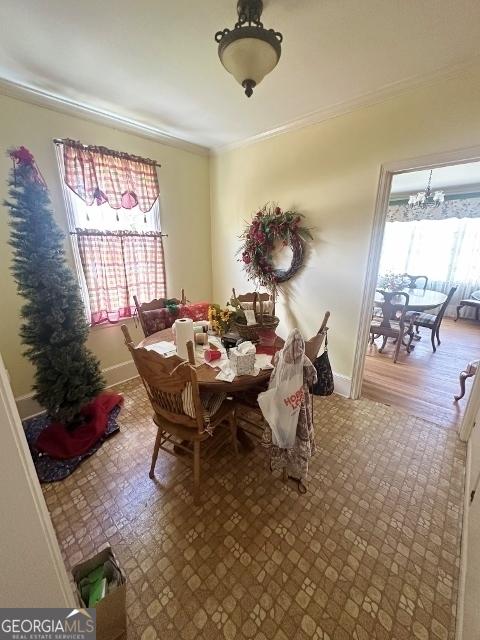 327 W Church St, Swainsboro, GA 30401 - dining space with baseboards, ornamental molding, and a chandelier