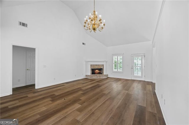 4368 Magnolia Bay Ln, Snellville, GA 30039 - unfurnished living room with dark wood-style flooring, visible vents, a chandelier, high vaulted ceiling, and a fireplace