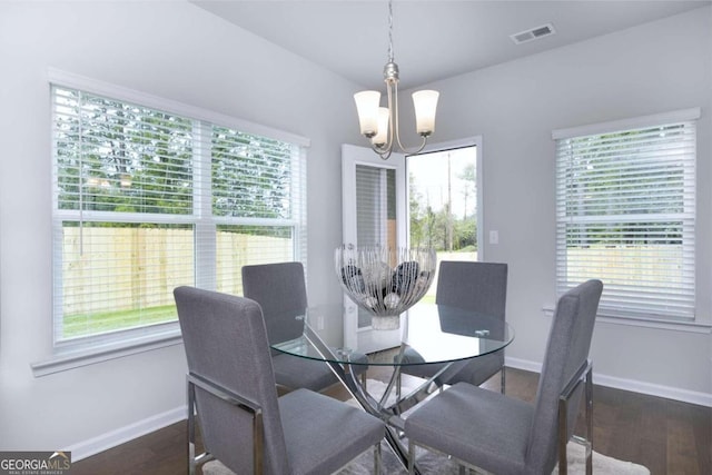 dining area with a chandelier, visible vents, baseboards, and a healthy amount of sunlight
