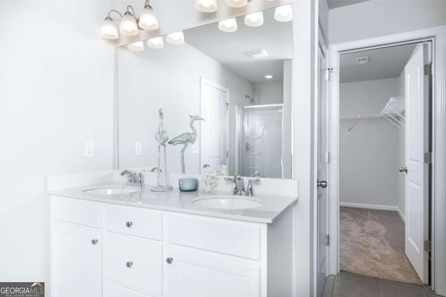 full bath with tile patterned floors, double vanity, a shower stall, and a sink