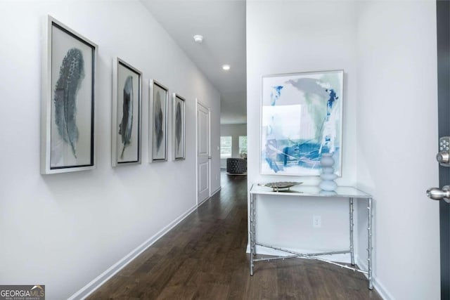 hallway featuring wood finished floors, baseboards, and recessed lighting