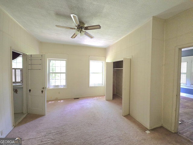 863 Boulevard, Macon, GA 31211 - unfurnished bedroom featuring light colored carpet, a textured ceiling, crown molding, and a closet