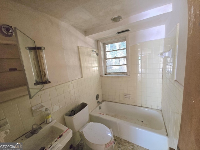 863 Boulevard, Macon, GA 31211 - bathroom featuring toilet, tile walls, bathing tub / shower combination, and visible vents