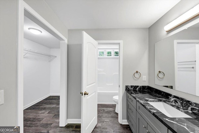212 Lake Forest Dr, Acworth, GA 30102 - full bath with vanity, wood finished floors, a spacious closet, and a bathtub