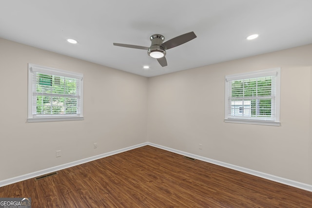 spare room with dark wood finished floors, visible vents, baseboards, ceiling fan, and recessed lighting