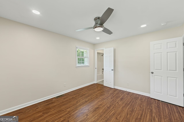 unfurnished bedroom featuring dark wood finished floors, visible vents, baseboards, and recessed lighting