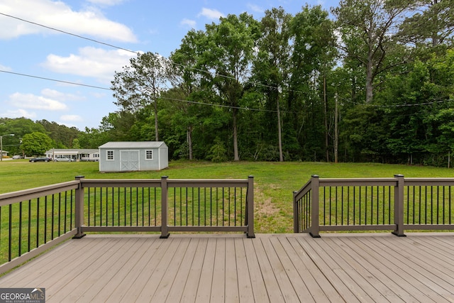 wooden deck featuring a yard, an outdoor structure, and a storage unit