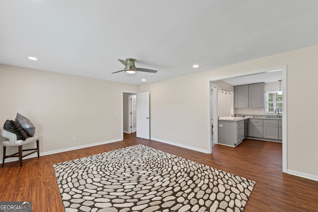 sitting room with baseboards, recessed lighting, dark wood finished floors, and ceiling fan