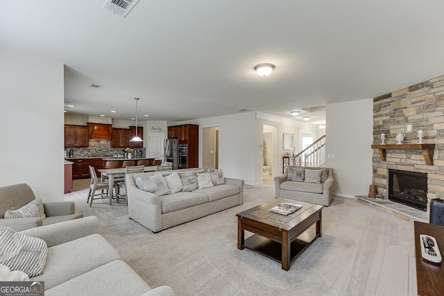 6438 Hickory Branch Dr, Hoschton, GA 30548 - living room with stairs, a fireplace, light carpet, and recessed lighting