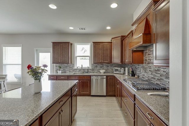 6438 Hickory Branch Dr, Hoschton, GA 30548 - kitchen featuring stainless steel appliances, tasteful backsplash, stone counters, custom exhaust hood, and recessed lighting