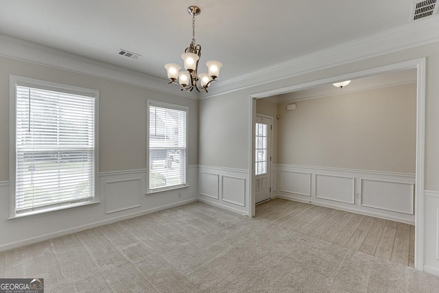 6438 Hickory Branch Dr, Hoschton, GA 30548 - carpeted spare room with a chandelier, ornamental molding, a wainscoted wall, a decorative wall, and wood finished floors