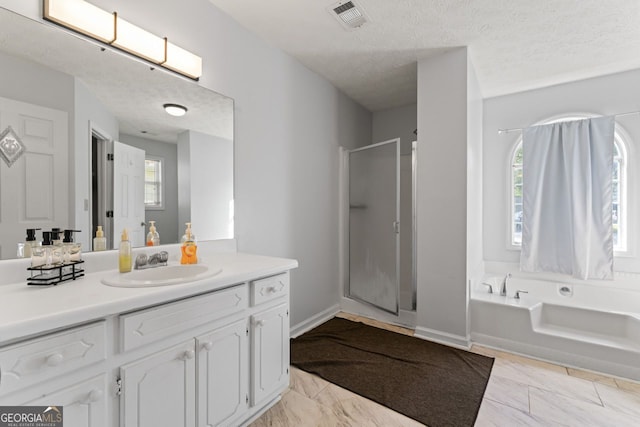 full bathroom with a garden tub, a stall shower, visible vents, marble finish floor, and vanity