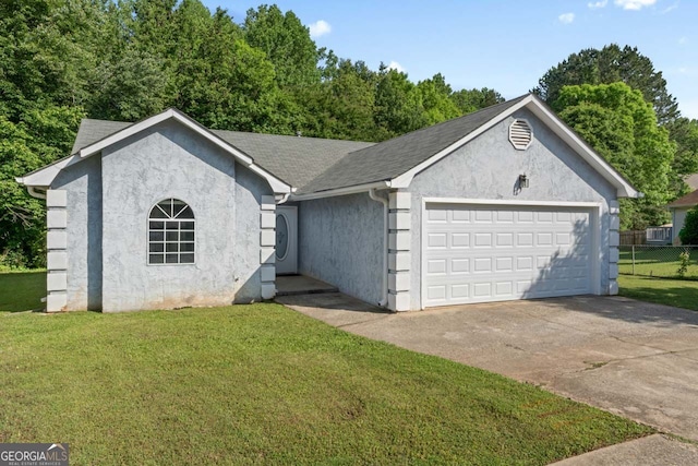 single story home featuring driveway, fence, an attached garage, stucco siding, and a front yard